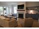 Cozy living room with a stone fireplace, custom built-ins, and comfortable seating, perfect for relaxing at 3510 Myrtle St, Edisto Island, SC 29438