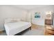 Bright bedroom with a king bed, wood flooring, and ensuite bathroom at 3510 Myrtle St, Edisto Island, SC 29438
