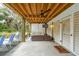 Covered outdoor living area with ceiling fan, TV, and comfortable seating, perfect for relaxing and entertaining guests at 3510 Myrtle St, Edisto Island, SC 29438