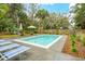 Inviting pool area with lounge chairs and lush landscaping for relaxing outdoors at 3510 Myrtle St, Edisto Island, SC 29438