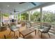 Inviting covered porch furnished with cozy seating, ceiling fans, and scenic views of the surrounding landscape at 3510 Myrtle St, Edisto Island, SC 29438