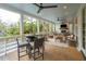 Relaxing outdoor porch space with comfortable seating, ceiling fans, and views of the lush yard at 3510 Myrtle St, Edisto Island, SC 29438
