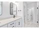 Bright bathroom features double sink vanity, quartz countertop, sleek black hardware, and marble-look tile flooring at 355 Wappoo Trace Ln, Summerville, SC 29486