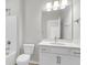 This bathroom has a white vanity with a large mirror, a toilet, and a shower-tub combo at 355 Wappoo Trace Ln, Summerville, SC 29486