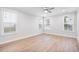 Bright, airy bedroom with hardwood floors and multiple windows offering ample natural light at 355 Wappoo Trace Ln, Summerville, SC 29486