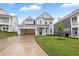 Charming light blue two-story home with an attached garage and a well-manicured lawn at 355 Wappoo Trace Ln, Summerville, SC 29486