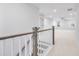Upstairs hallway with carpet, railing and door to bonus room at 355 Wappoo Trace Ln, Summerville, SC 29486