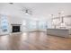 Open-concept living area with fireplace, wood floors, and seamless connection to the kitchen at 355 Wappoo Trace Ln, Summerville, SC 29486