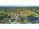 A picturesque aerial view shows homes nestled in a wooded neighborhood near a pond and golf course at 3584 Somerset Hills Ct, Mount Pleasant, SC 29466