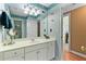 Bathroom with a fishy accent wall, a bright white vanity, and a lighted makeup mirror at 3584 Somerset Hills Ct, Mount Pleasant, SC 29466