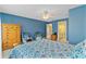 Bright bedroom with blue walls, natural light, ceiling fan, and a decorative patterned comforter at 3584 Somerset Hills Ct, Mount Pleasant, SC 29466