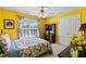 Bright bedroom with yellow walls, floral accents, and a window overlooking the landscape at 3584 Somerset Hills Ct, Mount Pleasant, SC 29466