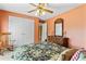 Bedroom with orange walls, floral bedding, carpet flooring, and a rocking chair at 3584 Somerset Hills Ct, Mount Pleasant, SC 29466
