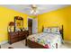 Bedroom with yellow walls, wood furnishings, carpet flooring, and bright decor at 3584 Somerset Hills Ct, Mount Pleasant, SC 29466