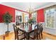 Bright dining room with hardwood floors, chandelier, and large windows letting in natural light at 3584 Somerset Hills Ct, Mount Pleasant, SC 29466