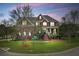 Charming two-story brick home with manicured lawn and inviting front porch with rocking chairs at 3584 Somerset Hills Ct, Mount Pleasant, SC 29466