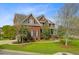 Beautiful brick house with a landscaped lawn, brick stairs, and a charming covered porch at 3584 Somerset Hills Ct, Mount Pleasant, SC 29466