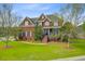 Classic brick home featuring a meticulously kept lawn, brick steps, and welcoming front porch at 3584 Somerset Hills Ct, Mount Pleasant, SC 29466