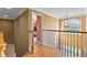 Second floor hallway with hardwood floors, chandelier, and views of the backyard at 3584 Somerset Hills Ct, Mount Pleasant, SC 29466