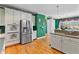 Well-lit kitchen featuring white cabinets, stainless steel appliances, and hardwood floors at 3584 Somerset Hills Ct, Mount Pleasant, SC 29466