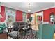 Cozy living room with hardwood floors, red walls, and large windows with curtains, offering ample natural light at 3584 Somerset Hills Ct, Mount Pleasant, SC 29466