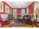 Elegant living room with hardwood floors, red walls, and large windows with curtains, creating a warm atmosphere at 3584 Somerset Hills Ct, Mount Pleasant, SC 29466