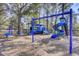 A vibrant blue and green playground sits on a bed of mulch beneath the shade of mature trees at 3584 Somerset Hills Ct, Mount Pleasant, SC 29466