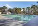 A serene swimming pool is surrounded by lush trees and offers a tranquil retreat at 3584 Somerset Hills Ct, Mount Pleasant, SC 29466