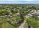 A high-angle view shows an area with homes, businesses, and recreational facilities amid lush greenery at 402 N Hickory Street St, Summerville, SC 29483