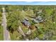 Overhead view of a red home with a charming porch and manicured yard, surrounded by lush greenery at 402 N Hickory Street St, Summerville, SC 29483