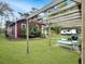 Charming home featuring a pergola-covered patio with outdoor seating and a lush green lawn at 402 N Hickory Street St, Summerville, SC 29483