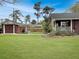Well-maintained backyard with green lawn, detached garage, and covered area at 402 N Hickory Street St, Summerville, SC 29483