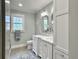 Bathroom featuring double sink vanity, tile floors, and a linen closet at 402 N Hickory Street St, Summerville, SC 29483
