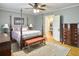 Spacious bedroom featuring a four-poster bed, hardwood floors, and a decorative rug at 402 N Hickory Street St, Summerville, SC 29483
