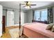 Comfortable bedroom with a four-poster bed, ceiling fan, and ample natural light at 402 N Hickory Street St, Summerville, SC 29483