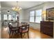 Dining room with chandelier, windows with sheer curtains, and dark wood table and chairs at 402 N Hickory Street St, Summerville, SC 29483