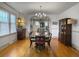 Charming dining room featuring hardwood floors, elegant lighting, and access to kitchen at 402 N Hickory Street St, Summerville, SC 29483