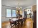 Bright dining room with chandelier, hardwood floors, and access to the kitchen area at 402 N Hickory Street St, Summerville, SC 29483
