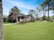 Attractive red home with a screened-in porch and well-manicured lawn, creating a welcoming atmosphere at 402 N Hickory Street St, Summerville, SC 29483