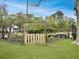 Lush fenced garden with wooden gate, raised planters, and verdant greenery at 402 N Hickory Street St, Summerville, SC 29483
