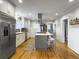 Open concept kitchen features stainless appliances, butcher block counters, an island with seating, and hardwood flooring at 402 N Hickory Street St, Summerville, SC 29483