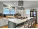 Kitchen with white cabinets, stainless appliances, wood countertops, marble island with gas range and seating at 402 N Hickory Street St, Summerville, SC 29483