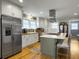 Bright kitchen with white cabinets, stainless steel appliances, butcher block counters, island with seating and gas range at 402 N Hickory Street St, Summerville, SC 29483
