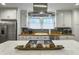 Kitchen view with white cabinets, stainless appliances, wood countertops, and marble island with gas range at 402 N Hickory Street St, Summerville, SC 29483
