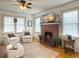 Inviting living room features a brick fireplace, ceiling fan, and lots of natural light at 402 N Hickory Street St, Summerville, SC 29483
