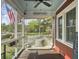 Cozy screened porch with a swing, cushioned seating, and charming details for relaxation at 402 N Hickory Street St, Summerville, SC 29483