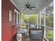 Relaxing screened porch with wicker furniture, ceiling fan, and views of the surrounding greenery at 402 N Hickory Street St, Summerville, SC 29483