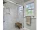 Modern bathroom with marble walk-in shower, tiled walls, and a window at 402 N Hickory Street St, Summerville, SC 29483