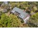 Aerial view of a beautiful brick home with mature landscaping, surrounded by trees and serene environment at 4029 Gift Blvd, Johns Island, SC 29455