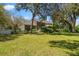 Expansive backyard featuring a lush lawn, mature trees, and the rear of a well-maintained brick home at 4029 Gift Blvd, Johns Island, SC 29455